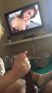 Cuckold interracial handjob while watching TV